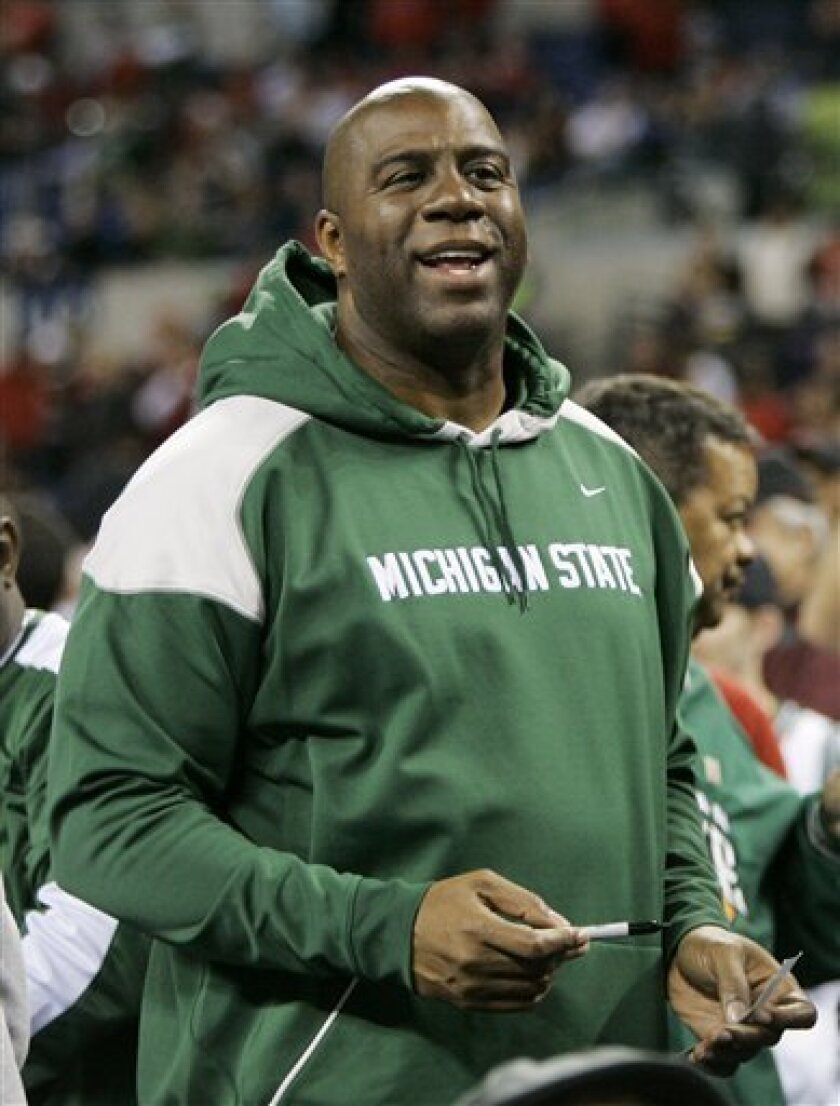 Former Michigan State and Los Angeles Lakers player Magic Johnson signs autographs at Lucas Oil Stadium in Indianapolis before the NCAA Midwest Regional men's college basketball tournament final between Michigan State and Louisville, Sunday, March 29, 2009. (AP Photo/Darron Cummings)