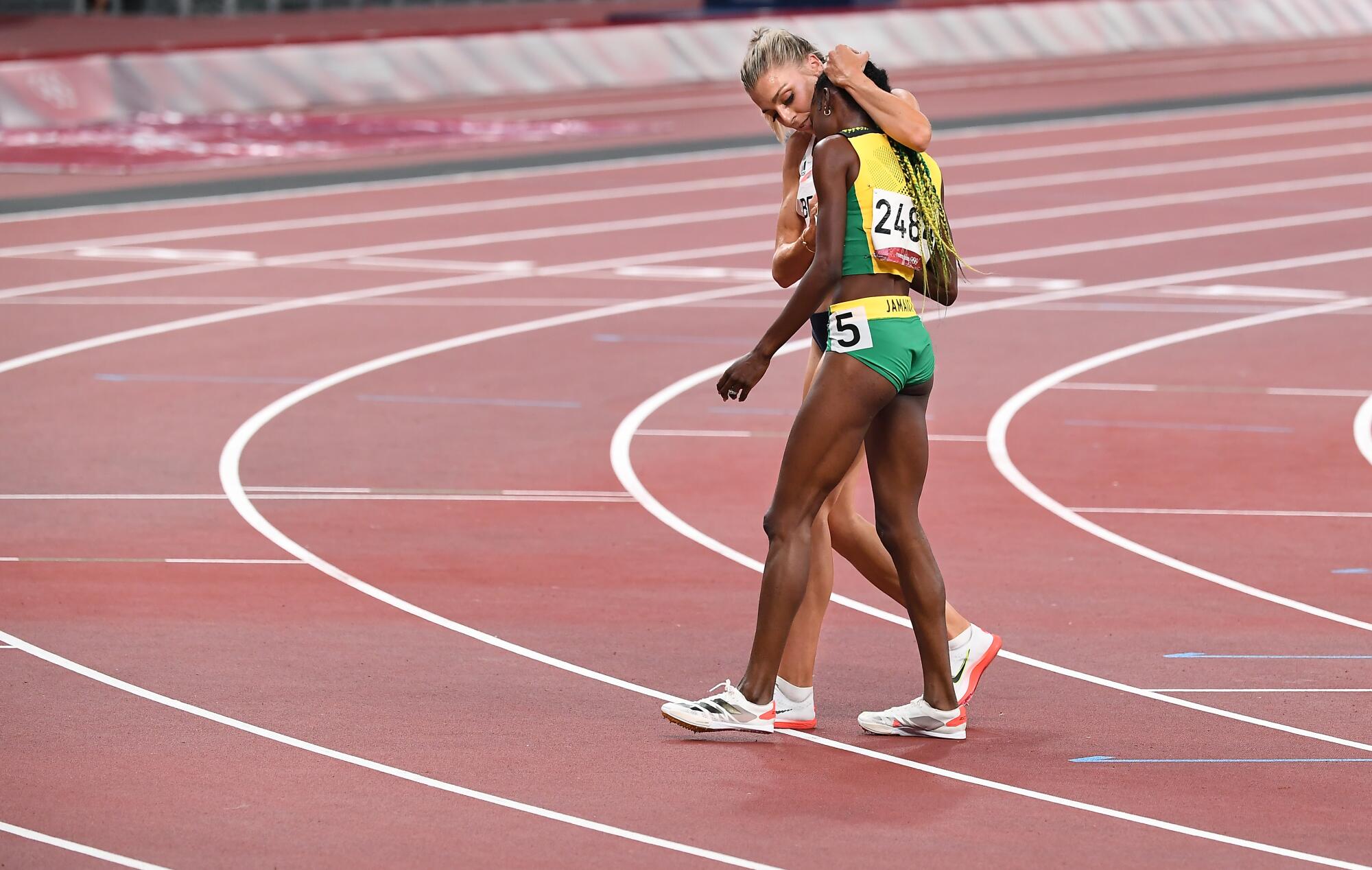 Britain's Alexandra Bell hugs Jamaica's Natoya Goule, foreground, after the 800-meter final.