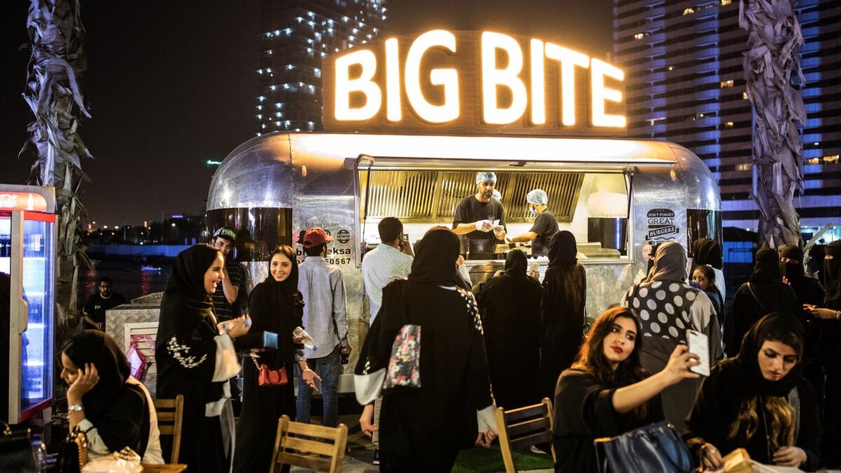 Men and women mix freely in the food truck section at the Land of O'hara festival in Jidda, Saudi Arabia.