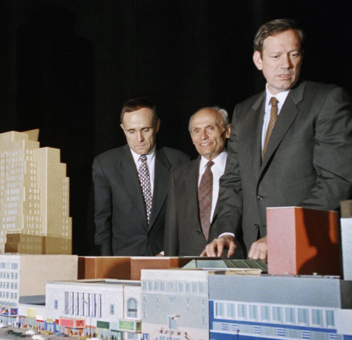 New York City Mayor Rudolph Giuliani, left, developer John Tishman, center, and New York Gov. George Pataki with a scale model of the 42nd Street development project in New York. Tishman's firm worked on some of the nation's largest development projects, including Disney's EPCOT Center and the World Trade Center in New York.