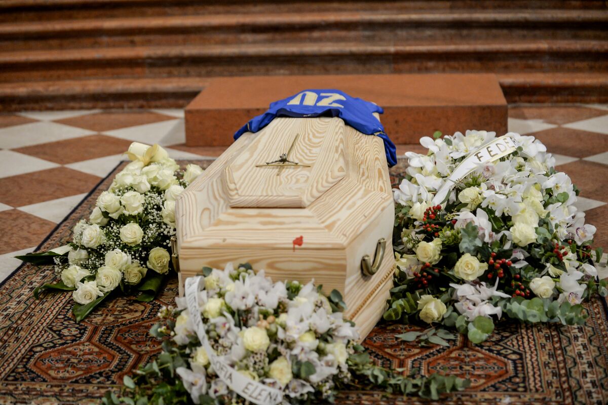 His jersey with number 20 of the winning World Cup team is placed on the coffin of Paolo Rossi during his funeral service, in Vicenza, Italy, Saturday, Dec. 12, 2020. Paolo Rossi, who led Italy to the 1982 World Cup title and later worked as a soccer commentator in his home country, died at the age of 64. (Claudio Furlan/LaPresse via AP)