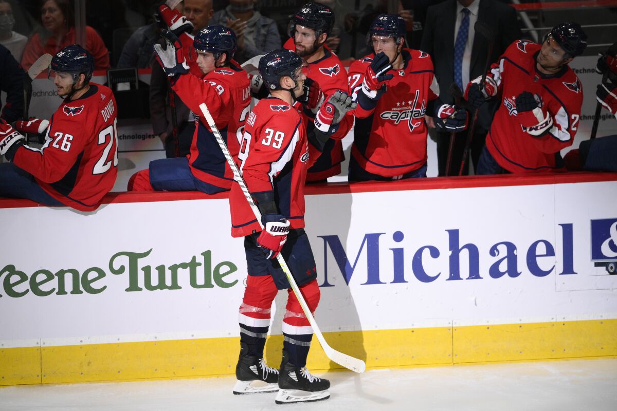 Washington Capitals right wing Anthony Mantha is congratulated for his goal during the third period of the team's NHL preseason hockey game against the Philadelphia Flyers, Friday, Oct. 8, 2021, in Washington. (AP Photo/Nick Wass)