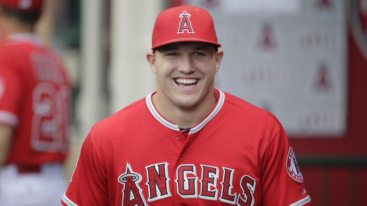 Angels center fielder Mike Trout smiles in the dugout before a game against the Houston Astros on June 22 at Angel Stadium.