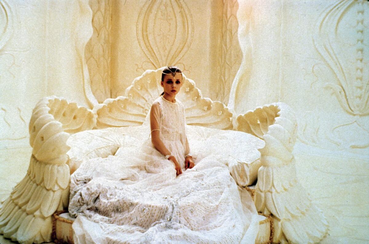 A person sits on an elaborate set in "The NeverEnding Story."