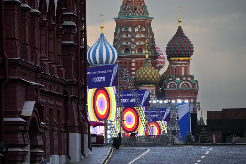 People make preparations for a concert at the Red Square, with constructions reading the words ''Donetsk, Luhansk, Zaporizhzhia, Kherson, Russia'', and the St. Basil's Cathedral and Lenin Mausoleum on the background, in Moscow, Russia, Thursday, Sept. 29, 2022. The Kremlin said that Russian President Vladimir Putin and the leaders of the four regions of Ukraine that held a referendum on joining Russia will attend a ceremony to sign documents on the regions' incorporation into Russia, which will be followed by a big concert on Red Square. (AP Photo/Alexander Zemlianichenko)