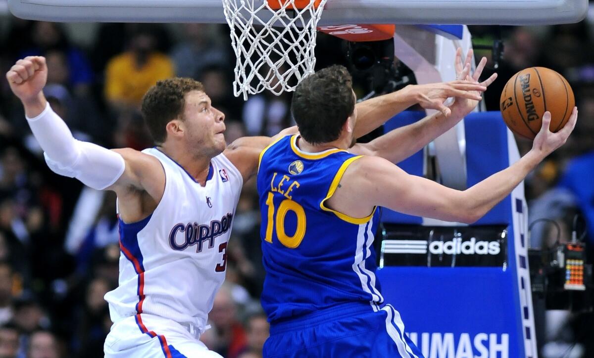 Clippers forward Blake Griffin tries to block Warriors forward David Lee's shot.