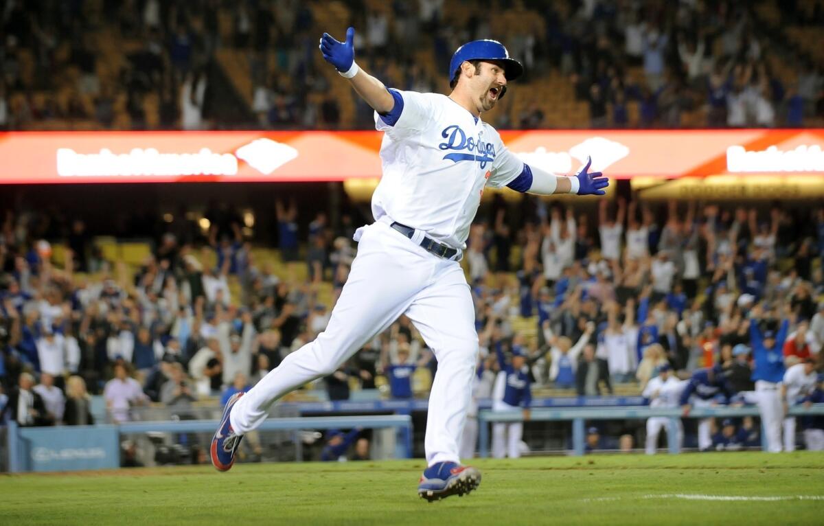 Dodgers outfielder Scott Van Slyke celebrates after hitting a two-run home run in the 11th inning to lift the Dodgers to a 5-3 win over the Arizona Diamondbacks on Tuesday.