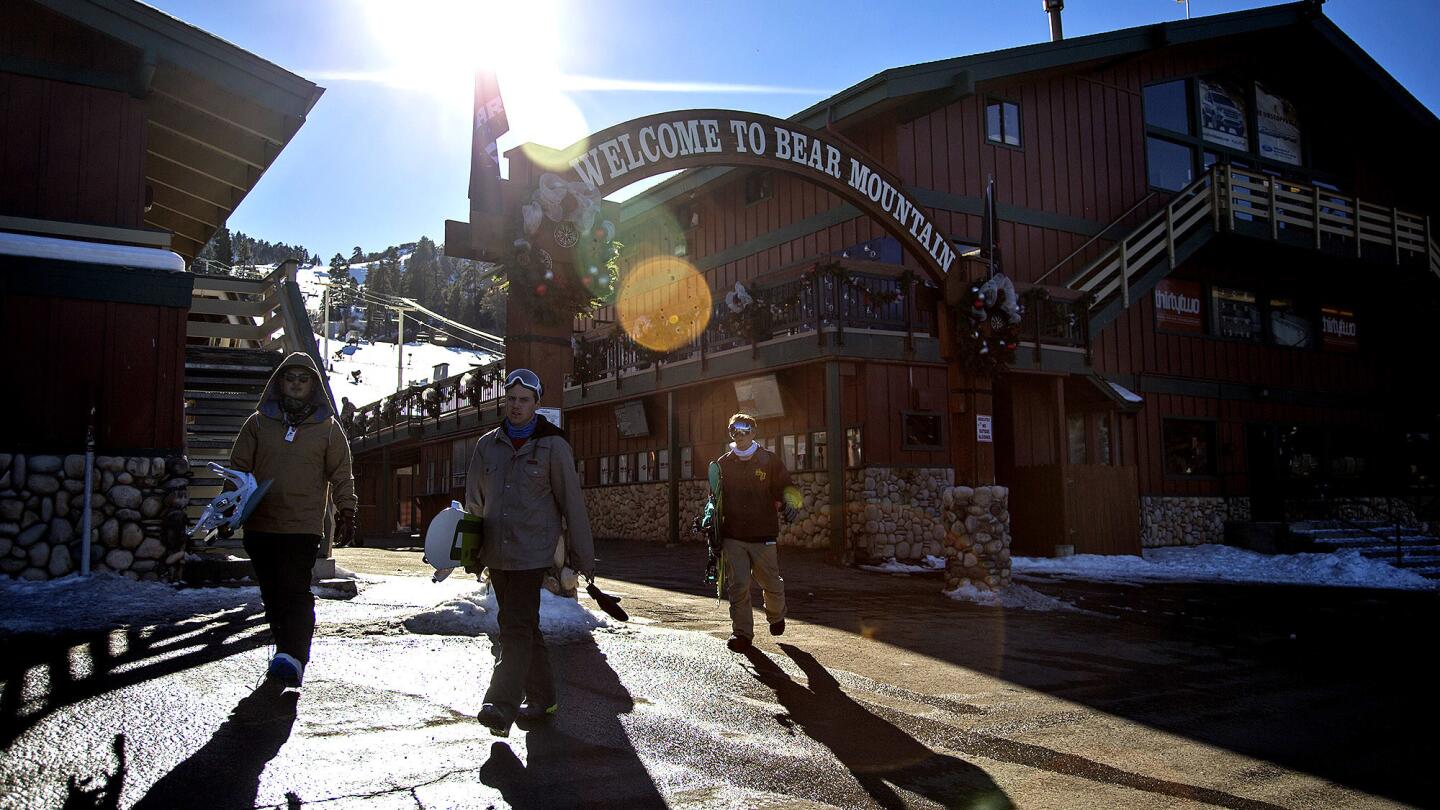 Snowboarders leave Bear Mountain on a sunny 50-degree day in December.