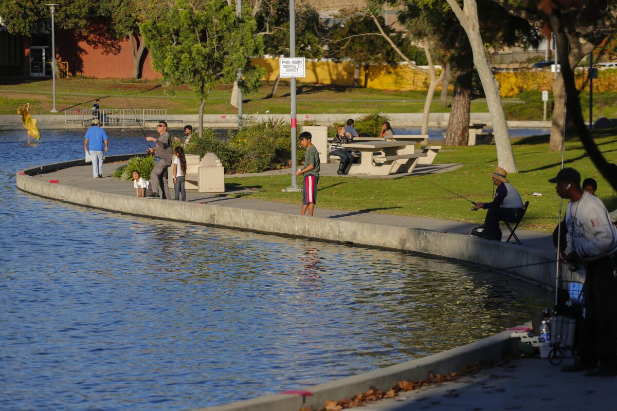 Residents enjoy the lake at Los Angeles County's Belvedere Park in East Los Angeles.