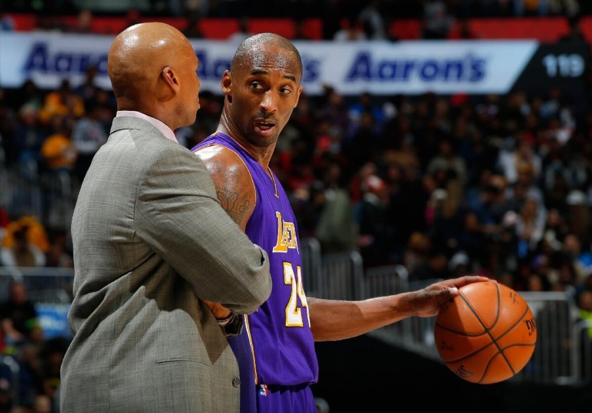 Lakers Coach Byron Scott and Kobe Bryant talk during a game against the Hawks on Dec. 4 in Atlanta. The Lakers lost, 100-87.
