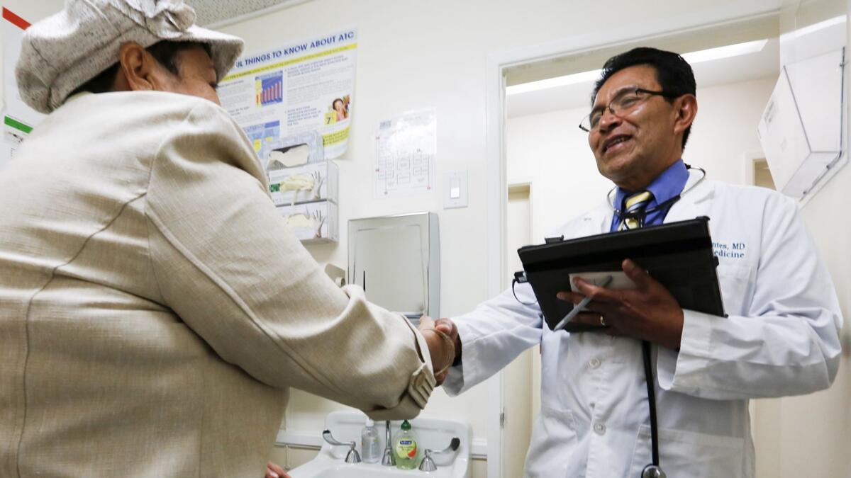 Dr. Juan Montes greets a patient in his Whittier clinic.