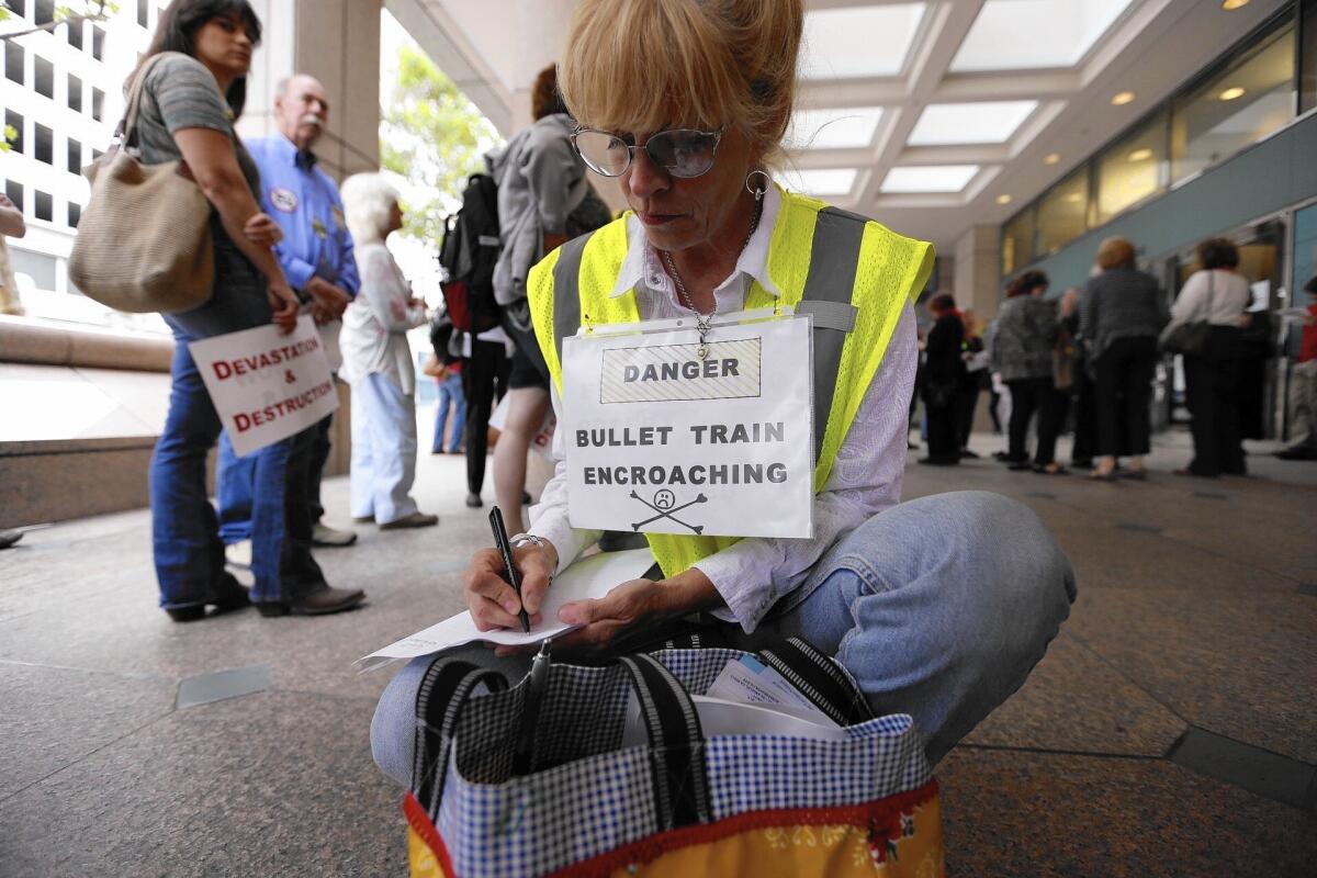 Shannon McGinnis of Kagel Canyon joins opponents of the current route for the high-speed rail line before they converge on a meeting of the California High-Speed Rail Authority on June 9.