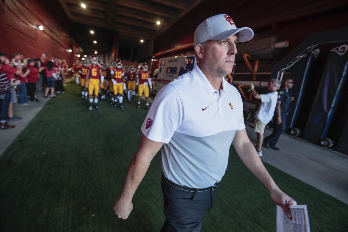 USC coach Clay Helton leads his team out of the tunnel before Saturday's 52-35 win over UCLA at the Coliseum.