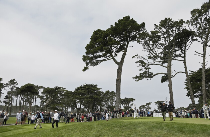 FILE - In this Saturday, May 2, 2015 file photo, Rory McIlroy, left, of Northern Ireland, and Hideki Matsuyama, right, of Japan, make their way down the fairway after hitting from the eighth tee of TPC Harding Park at the Match Play Championship in San Francisco. Harding Park hosts the PGA Championship on Aug. 6-9, the first major without spectators. (AP Photo/Eric Risberg, File)