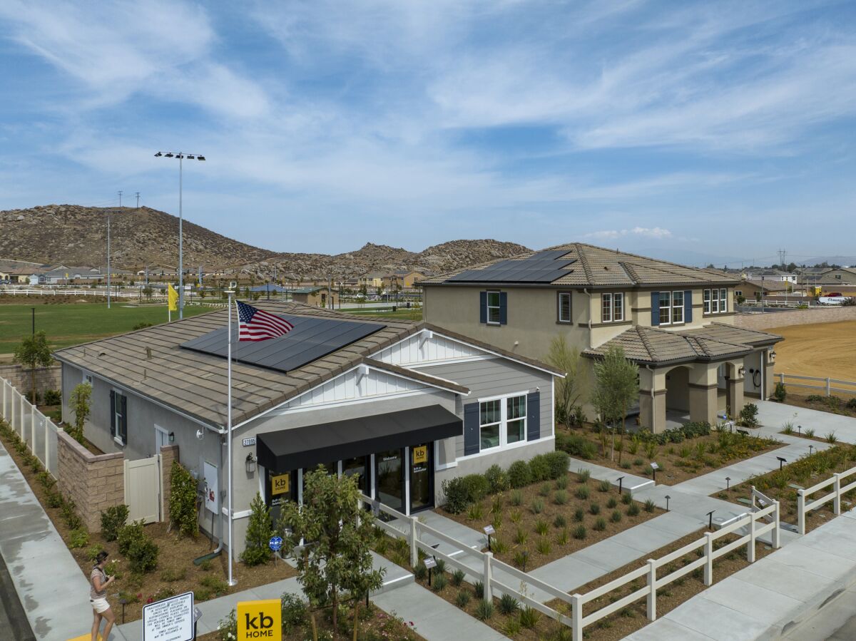 an aerial view of two homes with solar panels