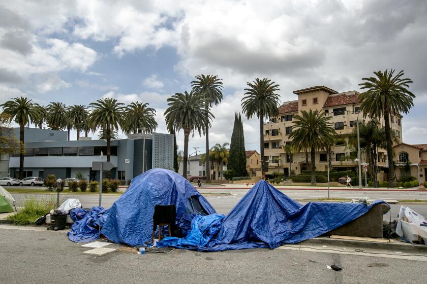 LOS ANGELES, CA-APRIL 14, 2023: A homeless encampment is located on the east side of San Vicente Blvd. just south of the Beverly Center in the city of Los Angeles. (Mel Melcon / Los Angeles Times)