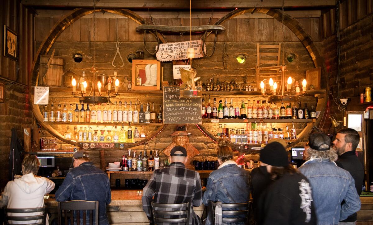 A rustic, wood-paneled bar.