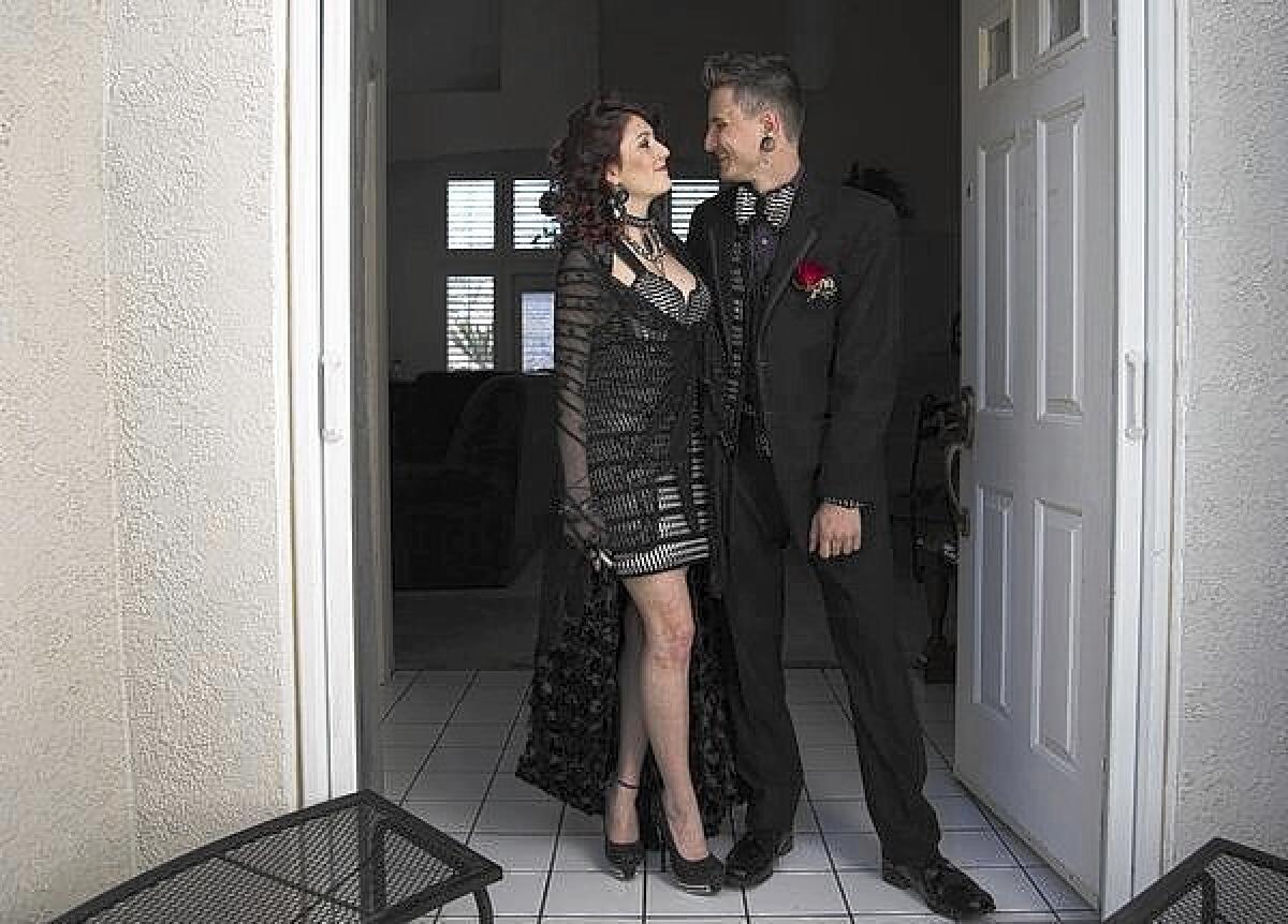Brie Fainblit of Palmdale, with her boyfriend, James Lawrence, shows off the soda-can-tab dress they made, with help from friends and relatives, before heading out to their senior prom.