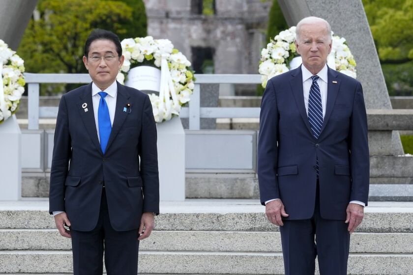 Prime Minister Fumio Kishida of Japan and with U.S. President Joe Biden, right, react after laying a wreath at the Hiroshima Peace Memorial Park in Hiroshima, Japan, Friday, May 19, 2023, during the G7 Summit. (AP Photo/Susan Walsh,Pool)