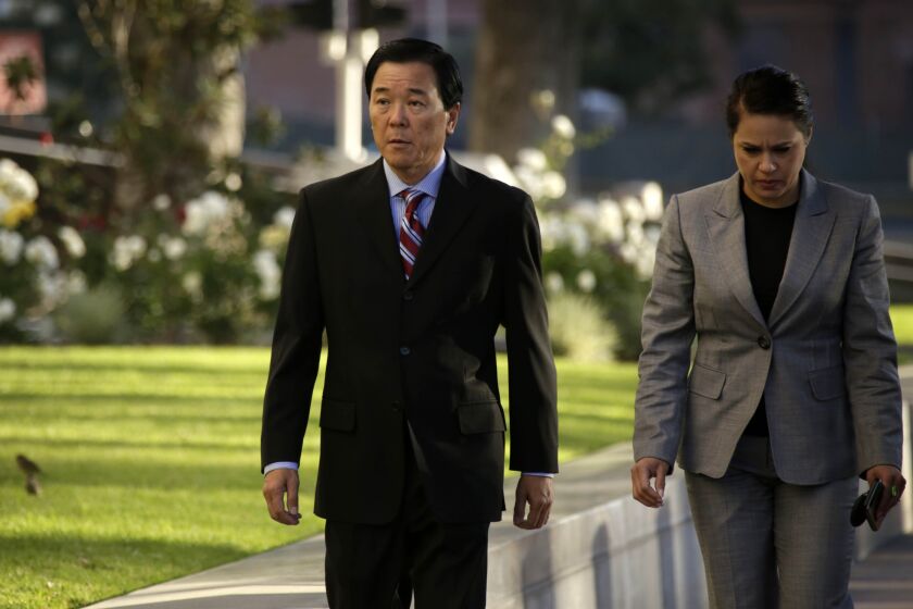 Paul Tanaka, left, arrives at Federal Court in Los Angeles, where the former second in command to former L.A. County Sheriff Lee Baca is charged with conspiracy and obstruction of justice.