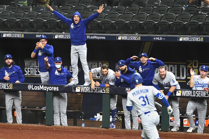 The Dodgers dugout erupts after a solo home run by Joc Pederson during the second inning in Game 5 of the World Series.