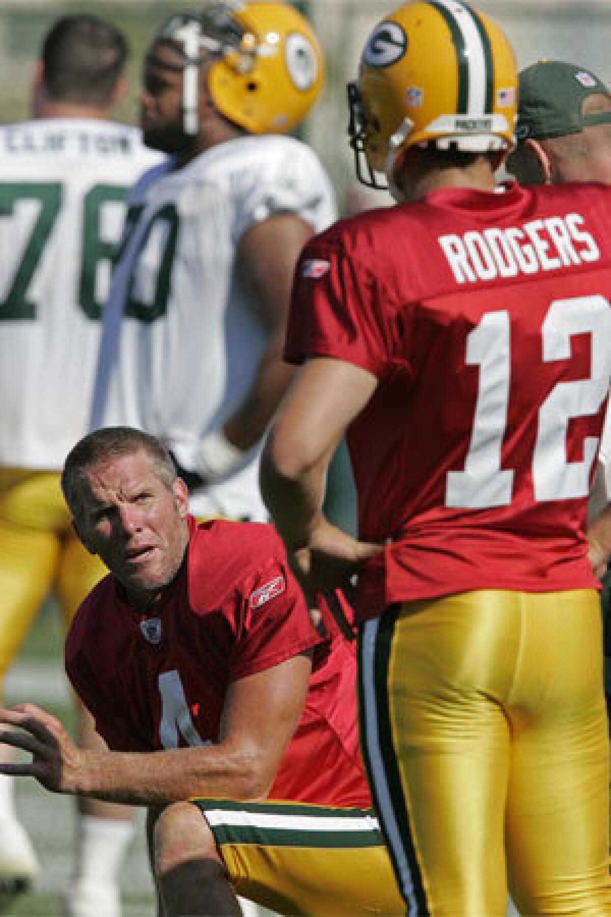 Brett Favre, left, chats with then-rookie quarterback Aaron Rodgers in 2005.