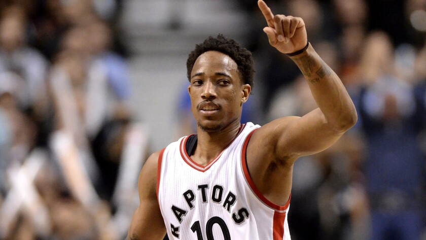 Raptors guard DeMar DeRozan (10) celebrates after making a three-pointer against the Celtics during the second half Friday night.