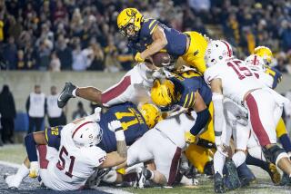 California running back Jaydn Ott fumbles while diving over a pile of Stanford and Cal players