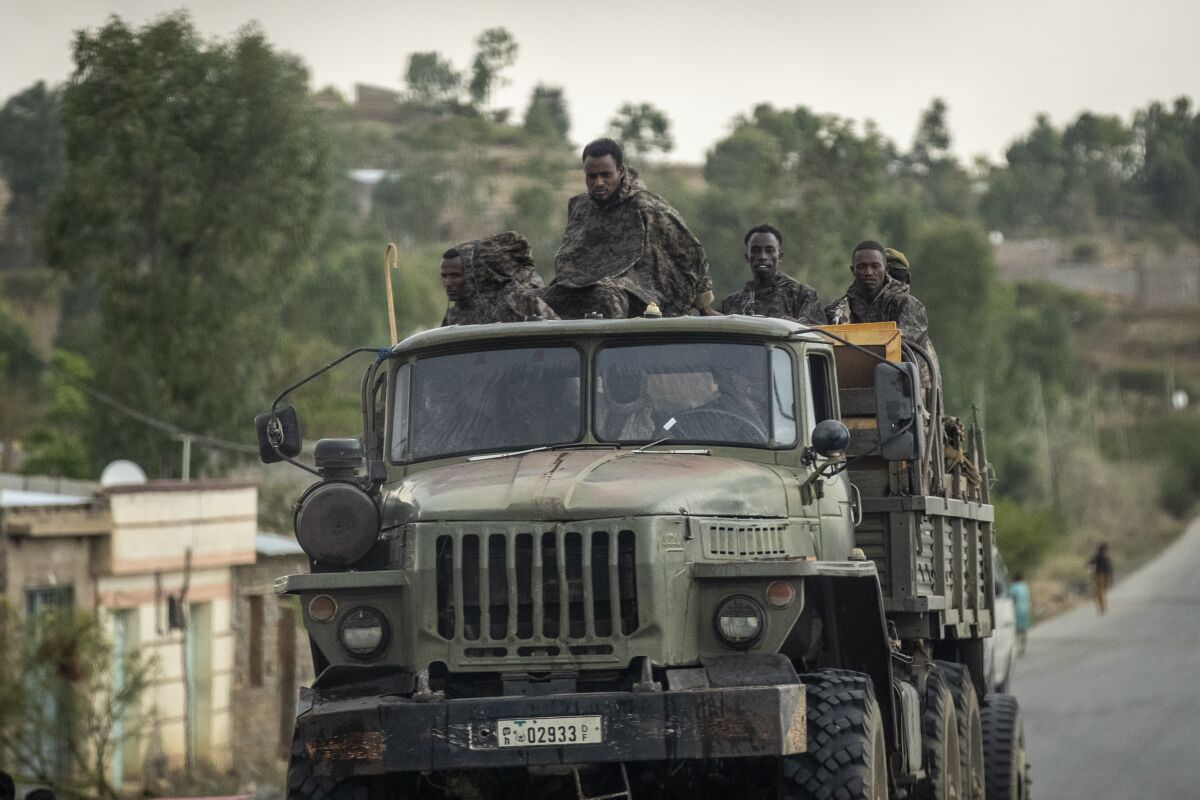 FILE - In this Tuesday, May 11, 2021 file photo, Ethiopian government soldiers ride in the back of a truck on a road leading to Abi Adi, in the Tigray region of northern Ethiopia. In an interview with The Associated Press Tuesday, Sept 28, 2021, the United Nations humanitarian chief Martin Griffiths calls the crisis in Ethiopia a "stain on our conscience" as children and others starve to death in the Tigray region under what the U.N. calls a de facto government blockade of food, medical supplies and fuel. (AP Photo/Ben Curtis, File)