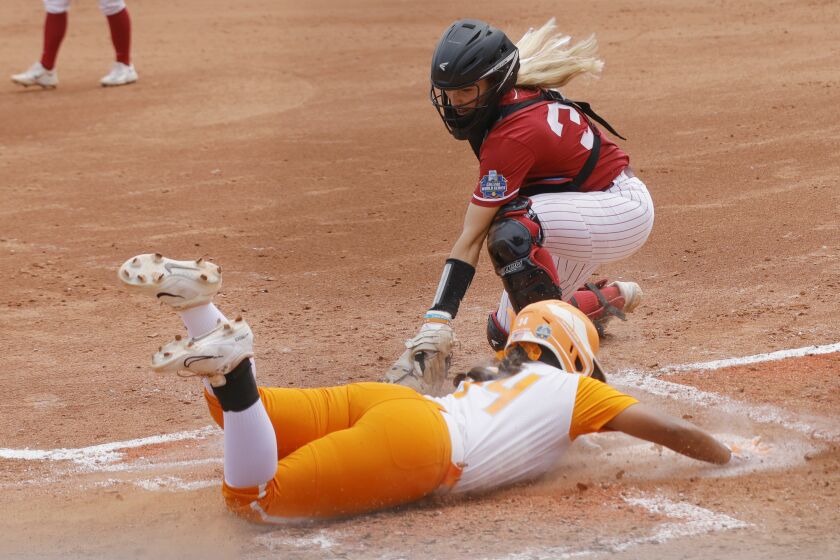 Tennessee's Destiny Rodriguez slides home to score beating the tag by Alabama catcher Ally Shipman during the second inning of an NCAA softball Women's College World Series game Thursday, June 1, 2023, in Oklahoma City. (AP Photo/Nate Billings)