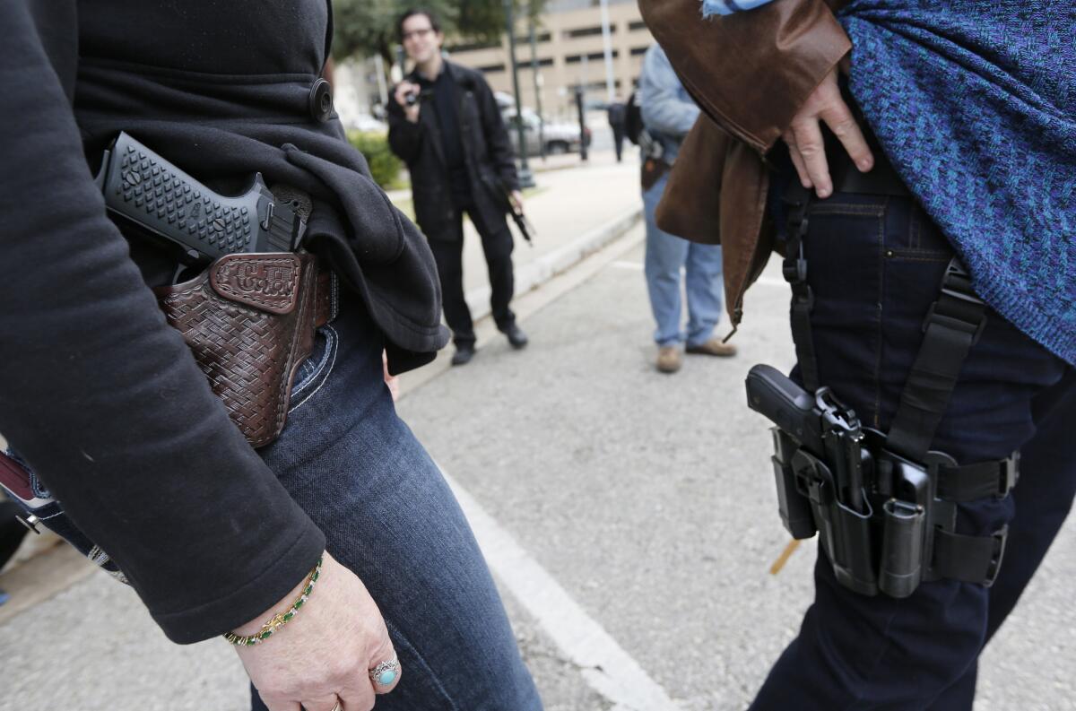 Two women participate in an open carry rally in Austin, Texas, on Jan. 1.