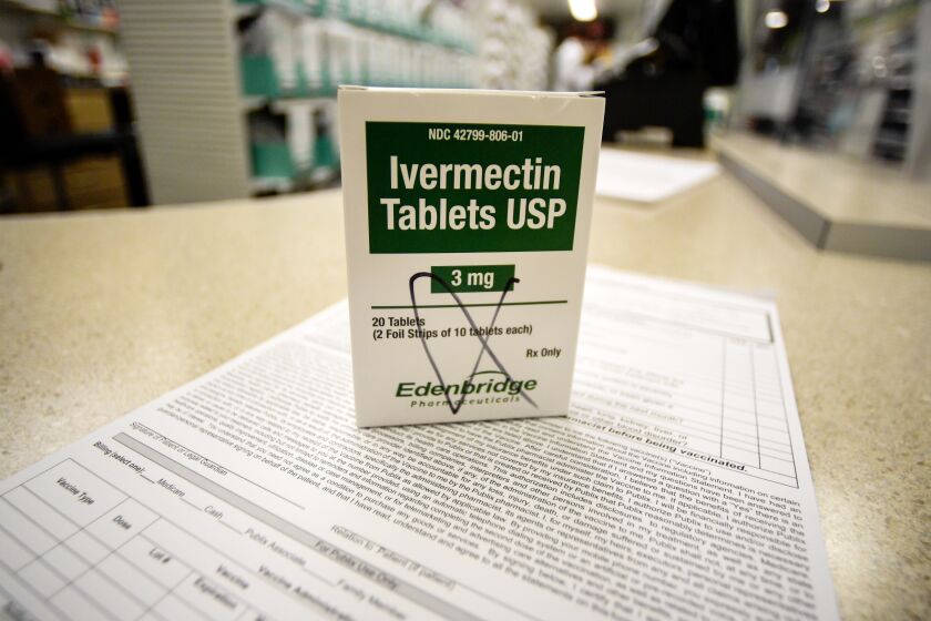 A box of ivermectin sits on a pharmacy counter. 