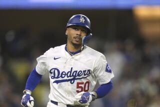 Los Angeles Dodgers' Mookie Betts runs to first base during a baseball game.