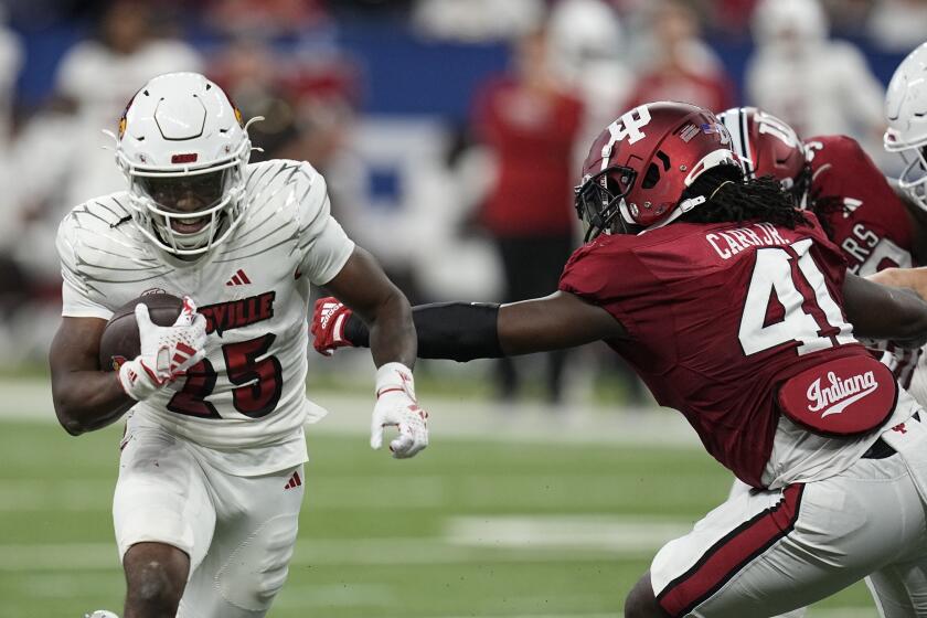 Louisville running back Jawhar Jordan runs past Indiana linebacker Lanell Carr Jr. for a touchdown during the first half of an NCAA college football game, Saturday, Sept. 16, 2023, in Indianapolis. (AP Photo/Darron Cummings)