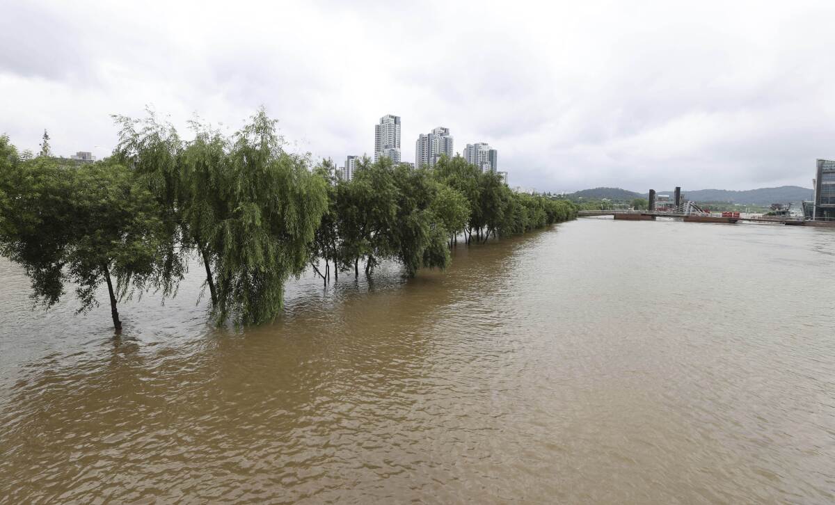 A part of a park near Han river is flooded after heavy rain in Seoul, South Korea, Sunday, Aug. 2, 2020. 