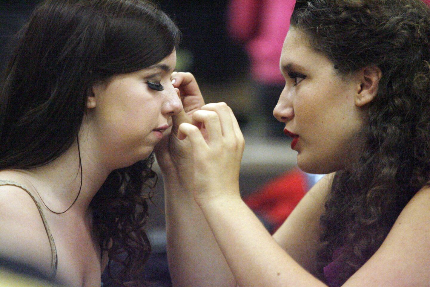Elle Willgues, left gets her eyelashes done by Bronwen Capshaw before their John Burroughs High School Vocal Music Assn. performance, "Burroughs on Broadway," which took place at John Burroughs High School in Burbank on Friday, October 12, 2012.