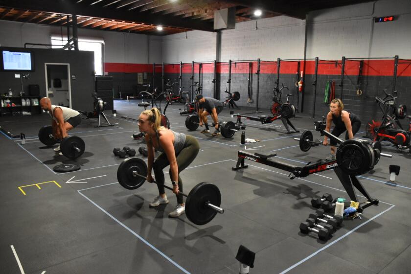 Performance360 members stay in their designated workout zones to practice social distancing.