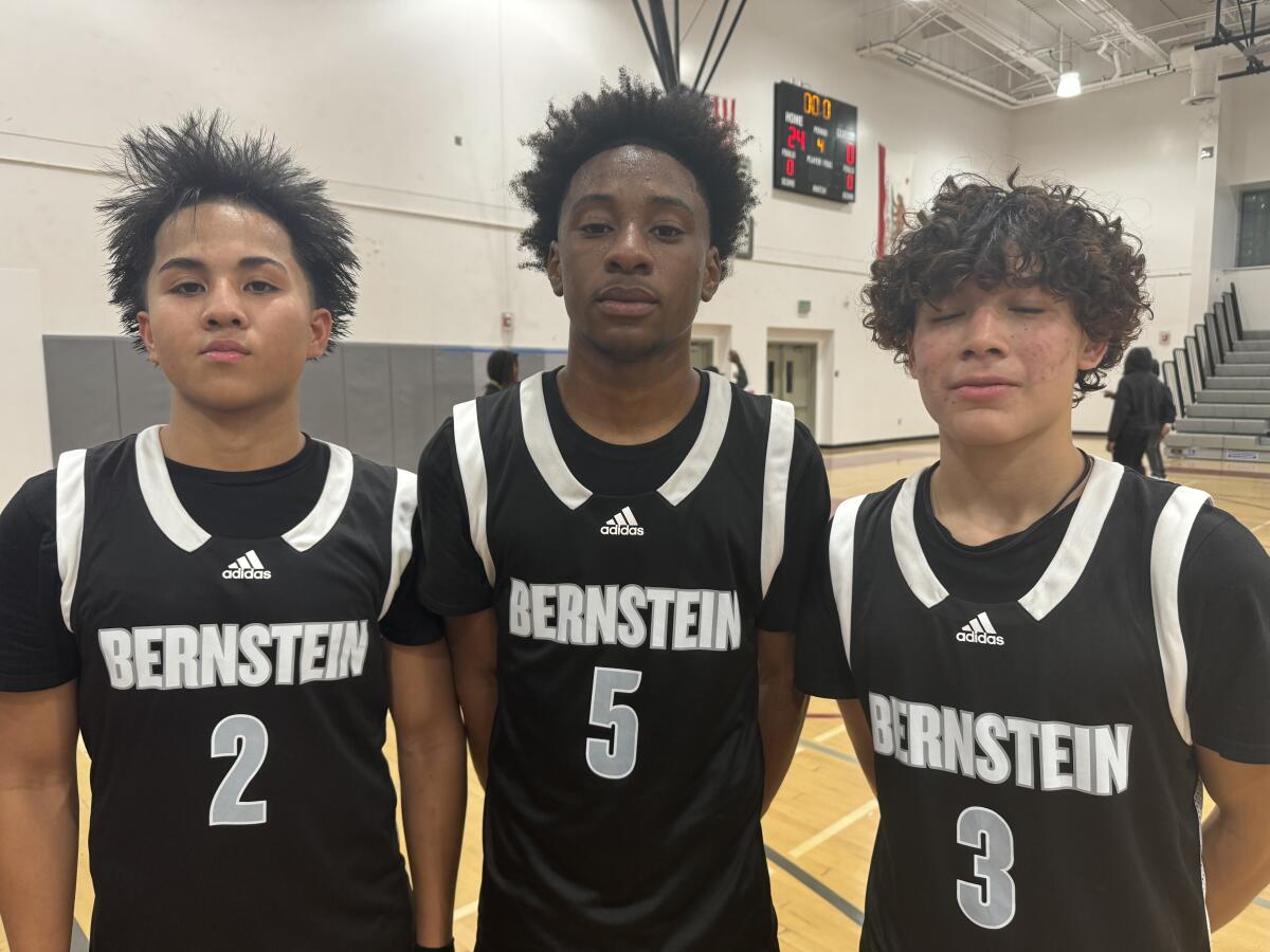Bernstein High guards Troy Agtang, Greg Griffin and Carlos Cordero pose together on the court.