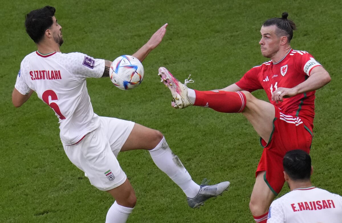 Players for Wales and Iran battle for the ball.