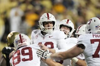 Stanford place kicker Joshua Karty, center, celebrates with teammates after kicking the winning field.