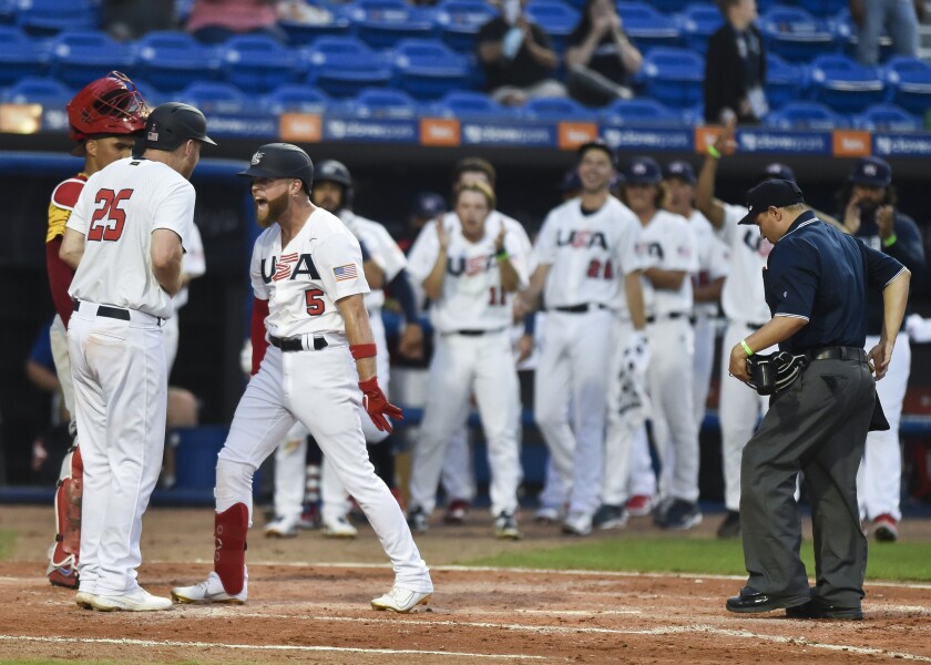 United States' Eric Filia (5) celebrates his home run with Todd Frazier (25) during the fourth inning against Venezuela in an Americas qualifying tournament baseball game Saturday, June 5, 2021, in Port St. Lucie, Fla. (Crystal Vander Weit/TCPalm.com via AP)