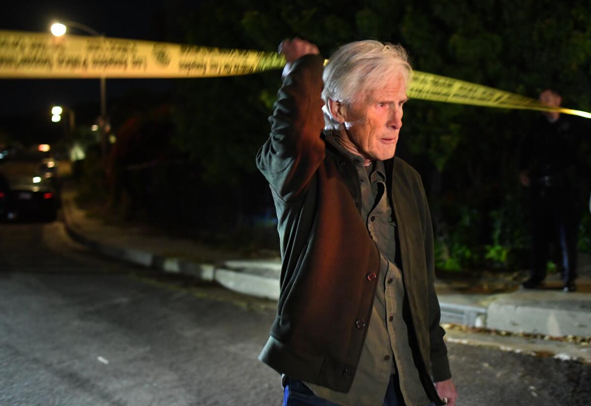 Keith Morrison crosses under the police tape near Perry's house in Los Angeles Saturday night.