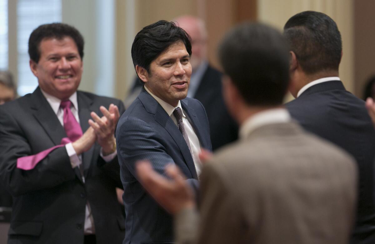 Sen. Kevin de Leon (D-Los Angeles), second from left, receives congratulations from other lawmakers after his election as Senate president pro tem in June. The new Senate affirmed his election on Monday.