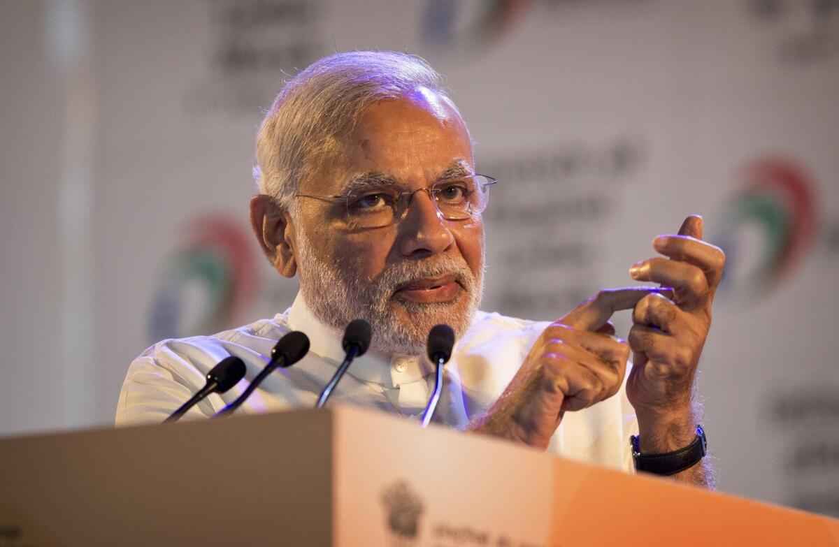 Indian Prime Minister Narendra Modi, makes a gesture of dialing a phone as he addresses people during the launch of the Digital India project in New Delhi on July 1.