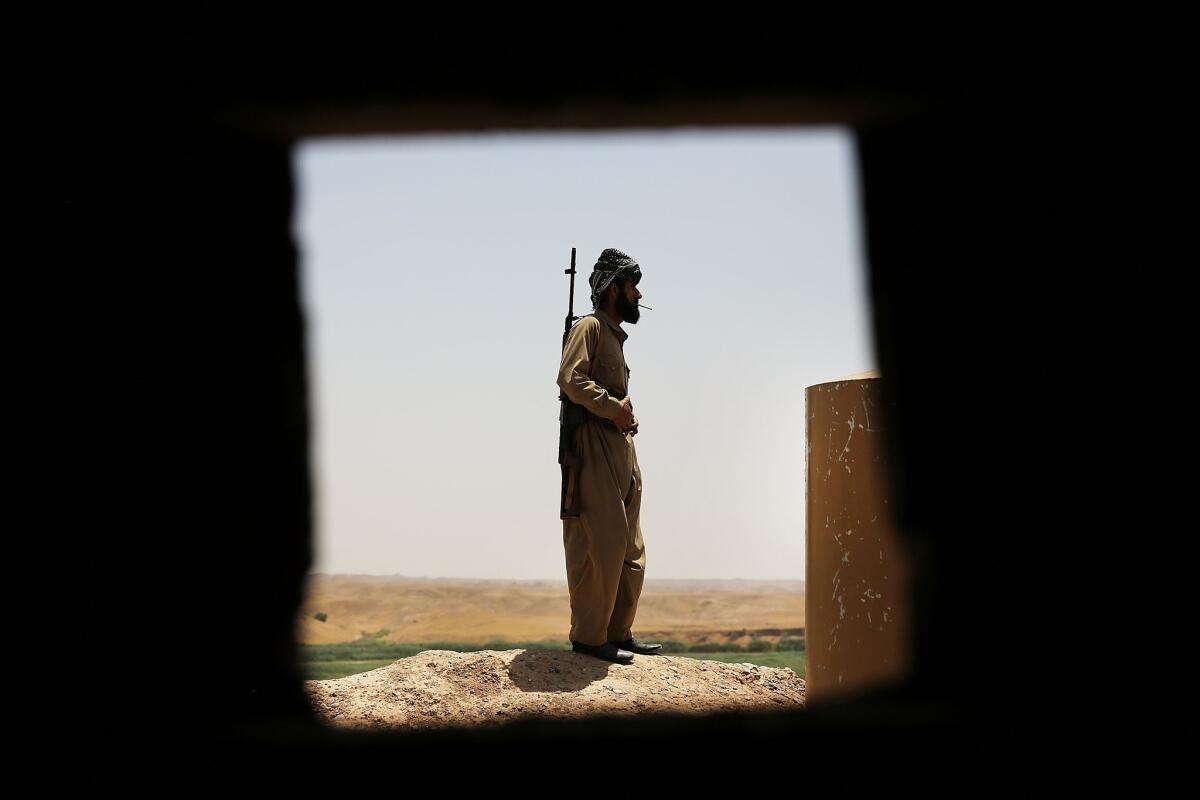 A peshmerga fighter keeps watch on the edge of Kirkuk in northern Iraq in early July. An Iraqi political struggle has arisen over an oil tanker off the coast of Texas, which holds $100 million worth of oil claimed by both Iraq and its semiautonomous Kurdish region.