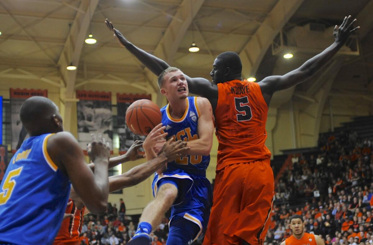 UCLA guard Bryce Alford loses the ball as Oregon State center Cheikh N'diaye defends during the first half of the Bruins' 66-55 loss to the Beavers.