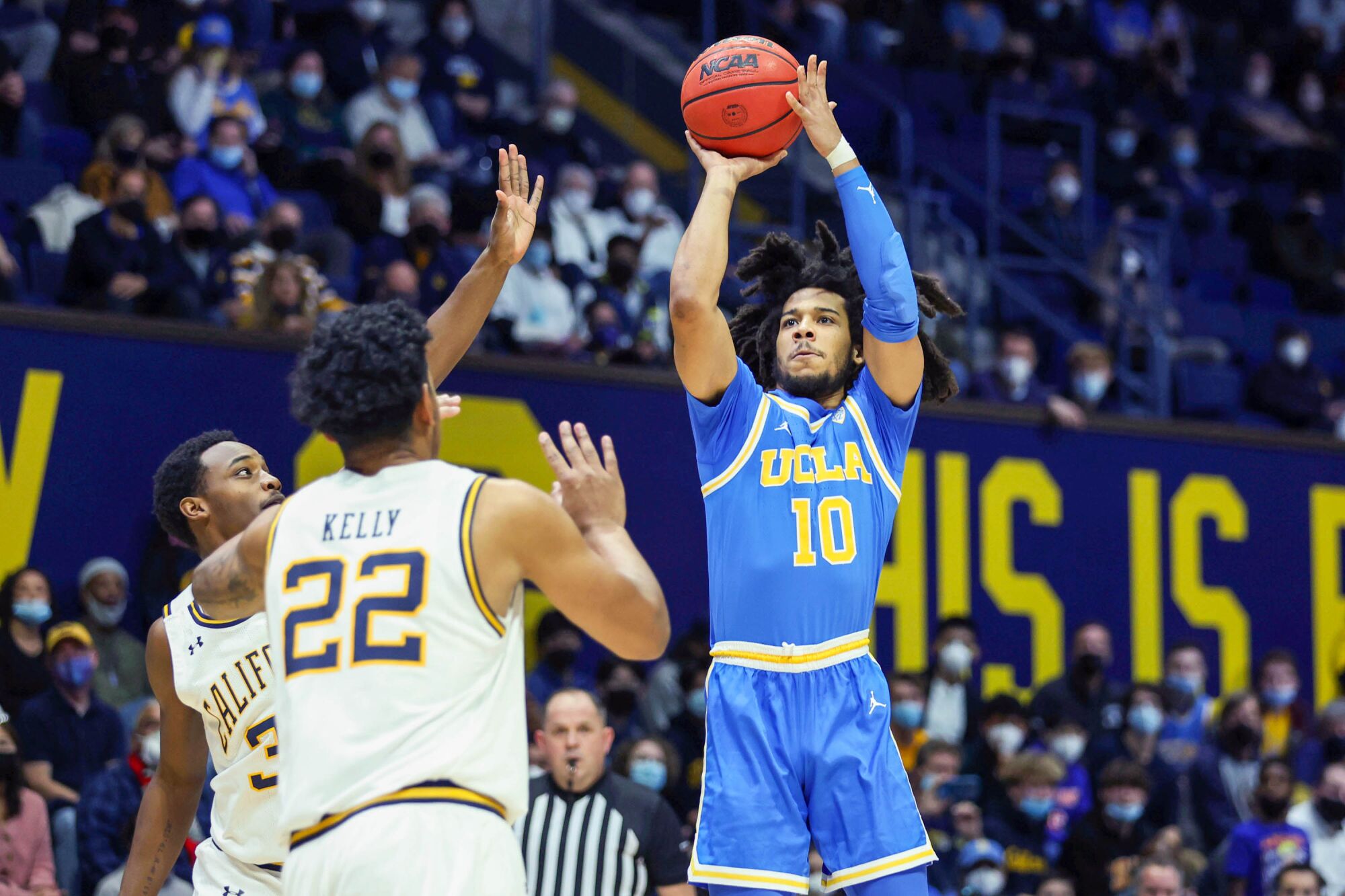 UCLA guard Tyger Campbell shoots against California's Jalen Celestine (32) and Andre Kelly (22) on Saturday in Berkeley.