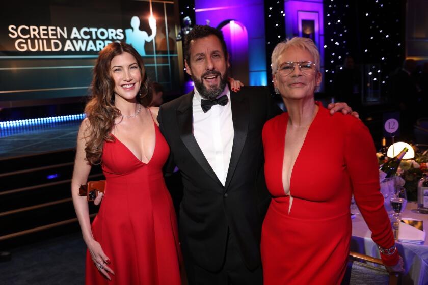 LOS ANGELES, CALIFORNIA - FEBRUARY 26th, 29th ANNUAL SCREEN ACTORS GUILD AWARDS - (L-R) Jackie Sandler and Adam Sandler and Jamie Lee Curtis during the Cocktail Reception at the 29th Annual Screen Actors Guild Award, held at the Fairmont Century Plaza in Los Angeles on February 26th, 2013. - (Photo by Jay L. Clendenin / Los Angeles Times)