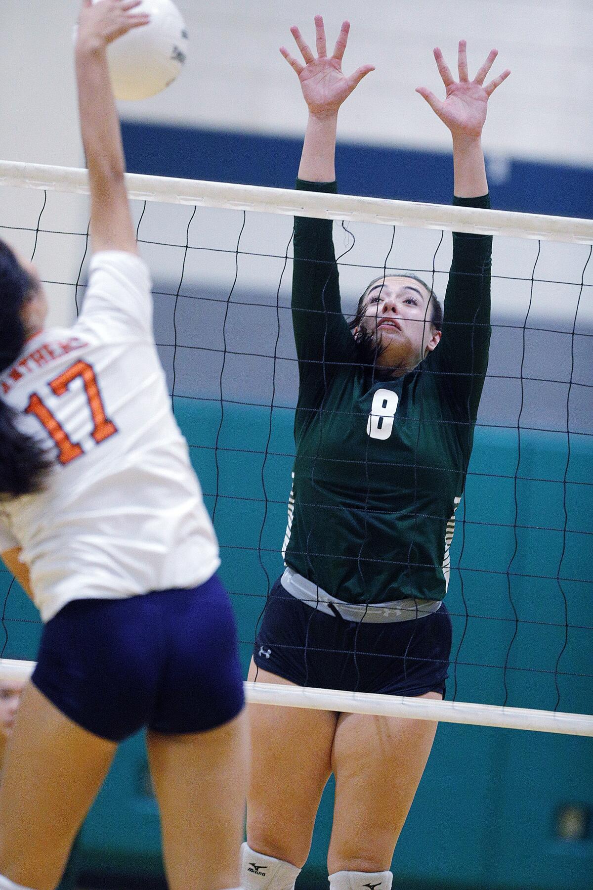 Providence's Liana Artunian reaches to block the kill by Polytechnic's Emily Wen in a Prep League girls' volleyball match at Providence High School on Tuesday, September 17, 2019.