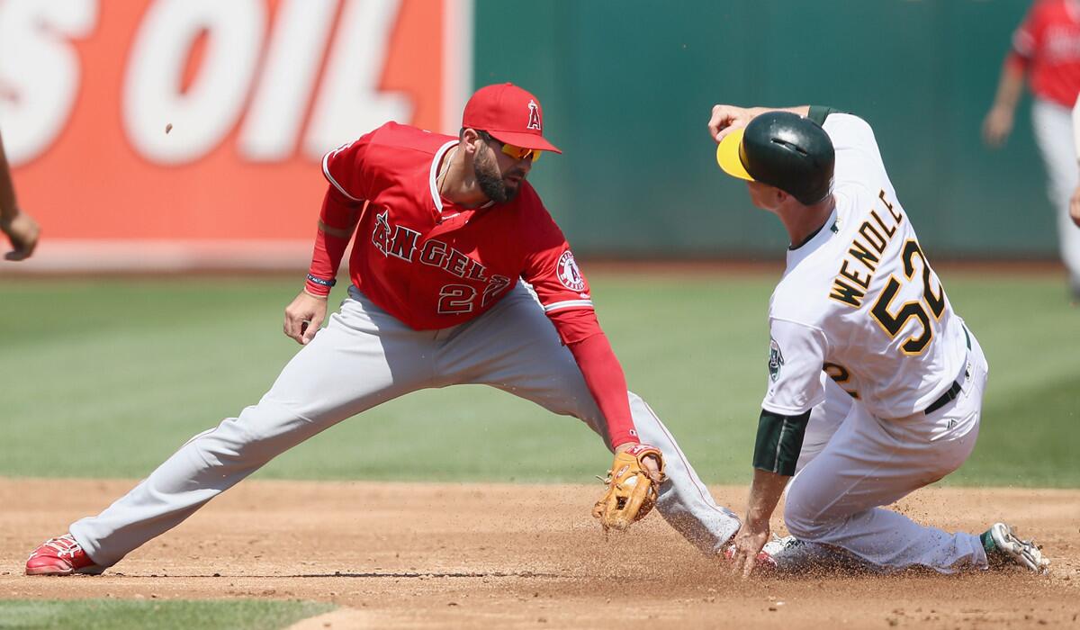 Oakland Athletics' Joey Wendle slides past Angels' Kaleb Cowart to steal second base in the third inning Wednesday.